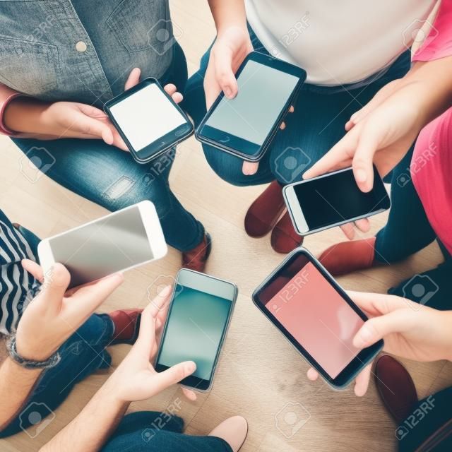 Young adults using smartphones in a circle social media and connection concept