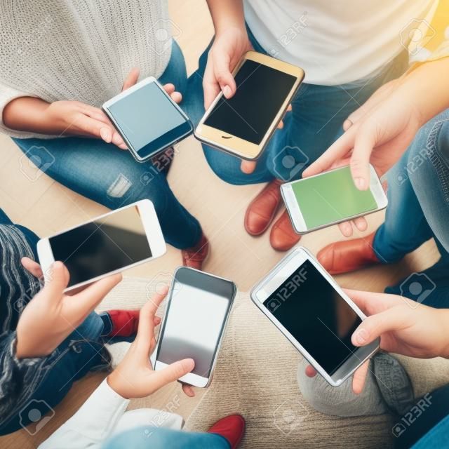 Young adults using smartphones in a circle social media and connection concept