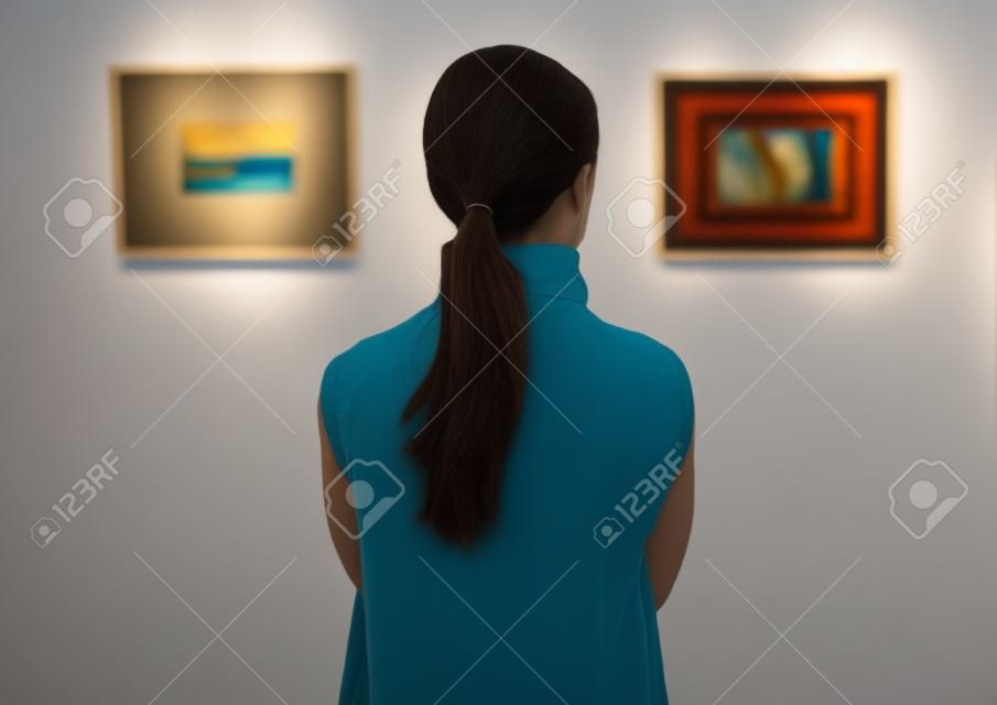 Woman looking at the art exhibition