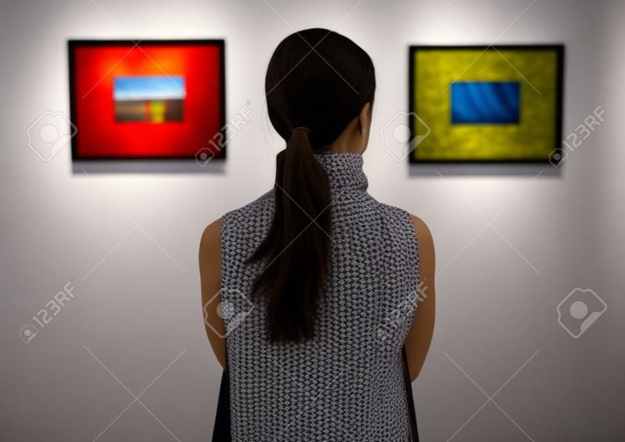 Woman looking at the art exhibition