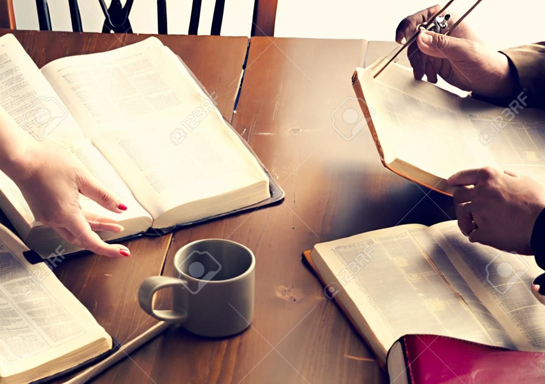 Two christianity people reading bible on the table