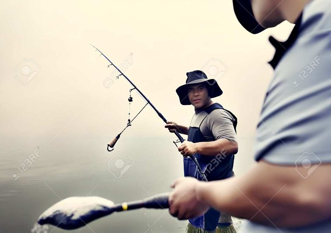 Men Fishing At The Lake Stock Photo, Picture and Royalty Free Image. Image  111782805.