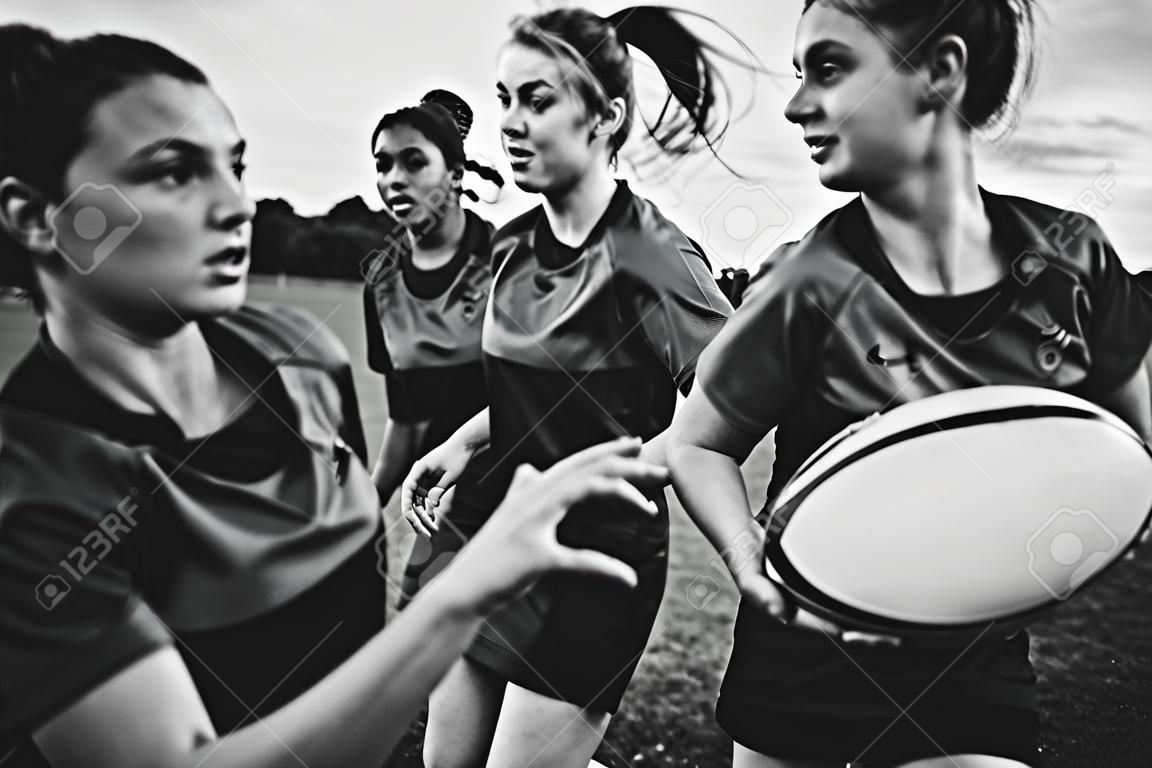 Female rugby players playing on the field