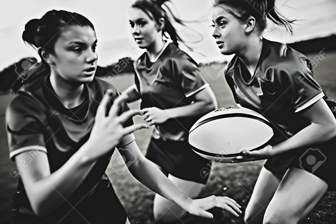 Female rugby players playing on the field
