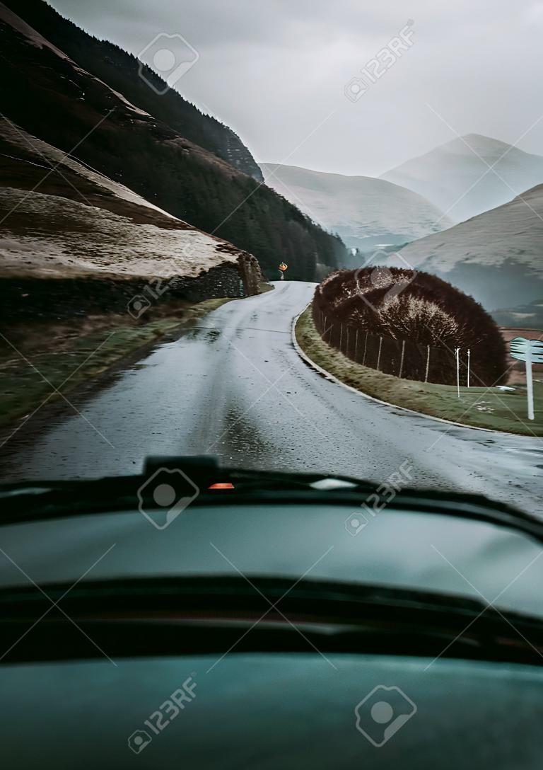 Man driving a car in the Highlands, Scotland