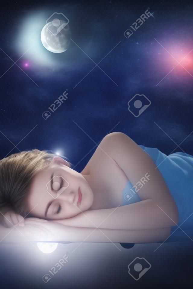 Girl sleeping at night on background of the moon