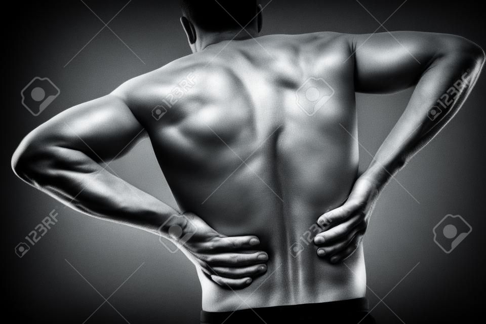 Acute pain in a male lower back, monochrome  image
