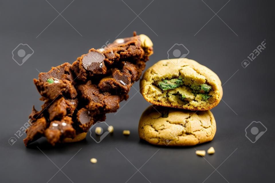 Detail of single cannabis nug over infused chocolate chips cookies - medical marijuana edibles concept
