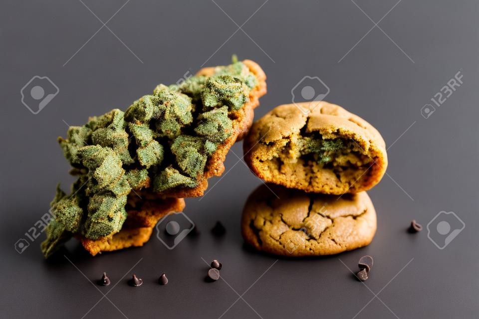 Detail of single cannabis nug over infused chocolate chips cookies - medical marijuana edibles concept