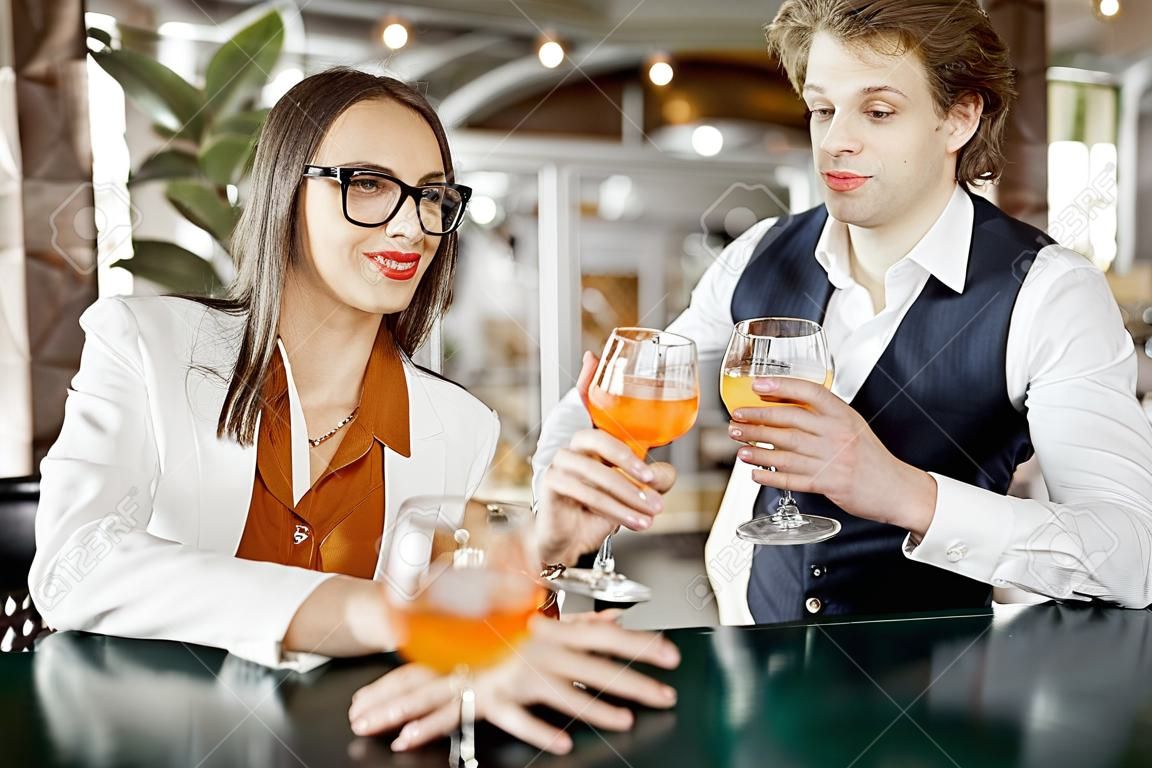 Business partners having unofficial meeting, drinking together some cocktails at the bar