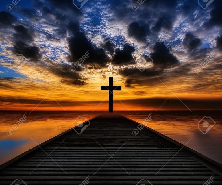 Silhouette of Christian cross appear at the end of the jetty dock at the clear cloudy sky atmosphere for peace and spiritual symbol of Christian people. Inspiration, resurrection hope and concept.