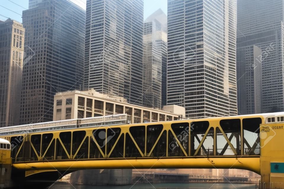 Subway train over the Chicago river with skyscrapers on the background