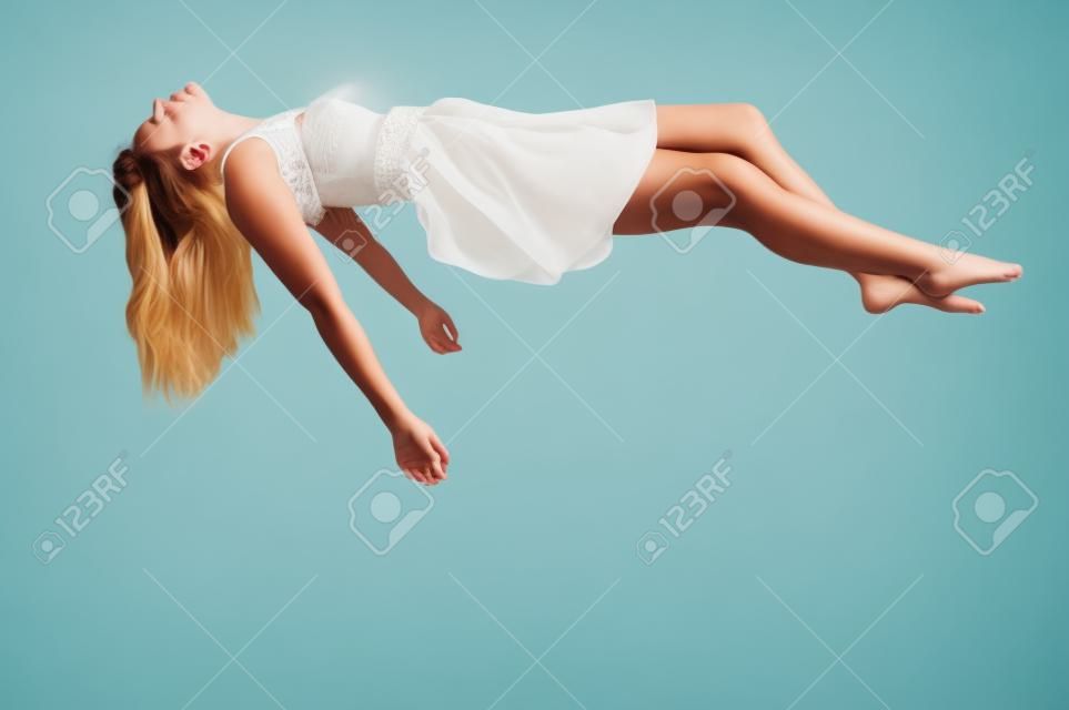 Beautiful young woman floating in the air