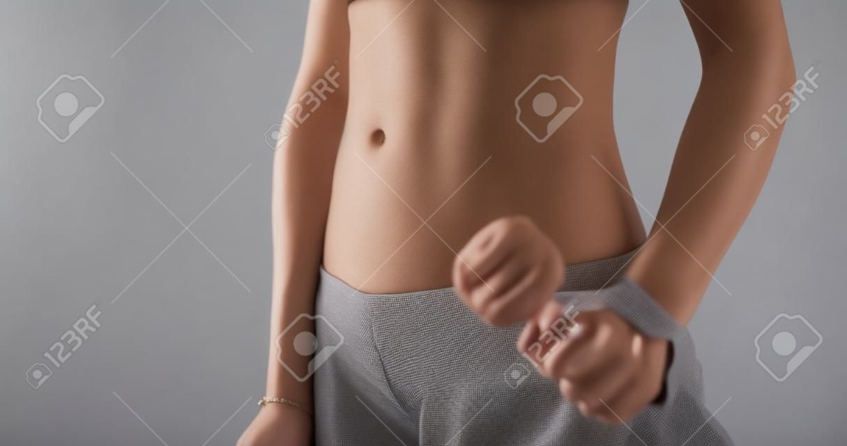 Portrait of slender Asian woman's mid-section waist