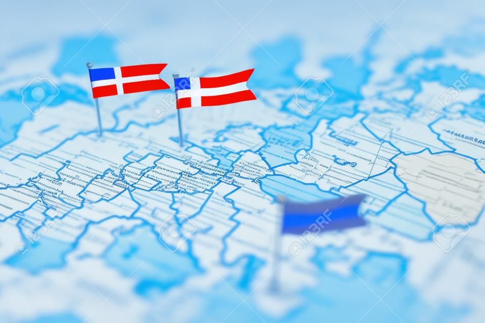 Finland and Sweden and Russian flags on Europe map. NATO flag in background