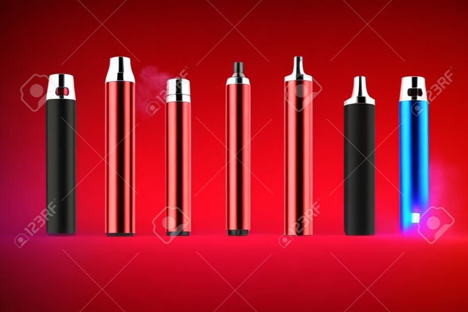 multicolored vape electronic cigarettes on a red background in the smoke