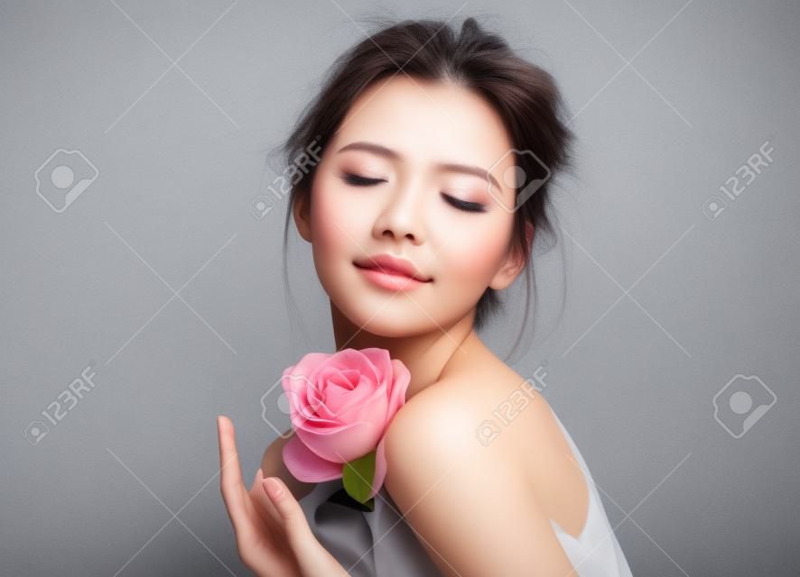Beautiful girl with closed eyes on grey background. Beauty & Skin care concept