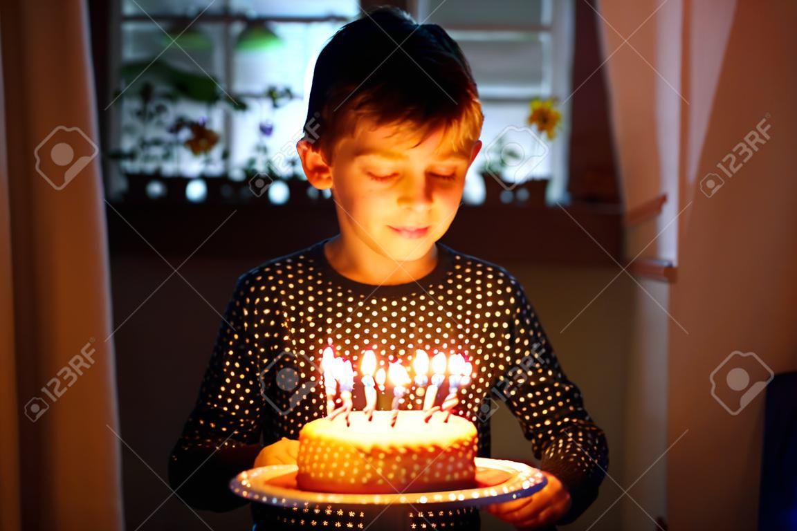 Adorable happy blond little kid boy celebrating his birthday.