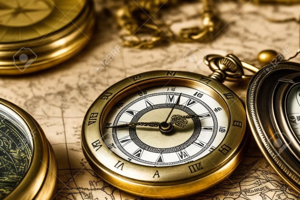 Vintage compass and pocket watch. Map of the Ancient World in 1565.