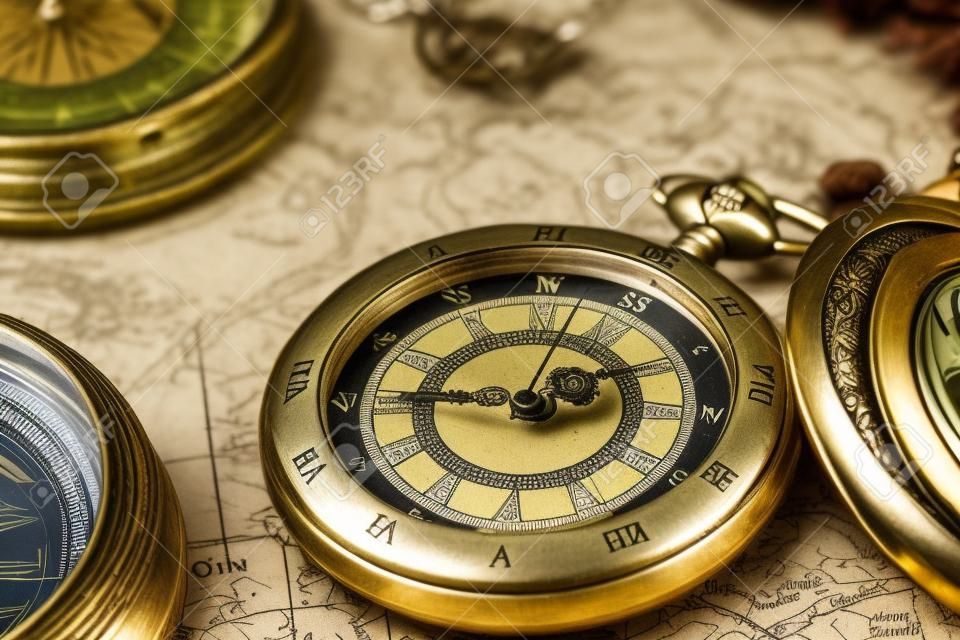 Vintage compass and pocket watch. Map of the Ancient World in 1565.