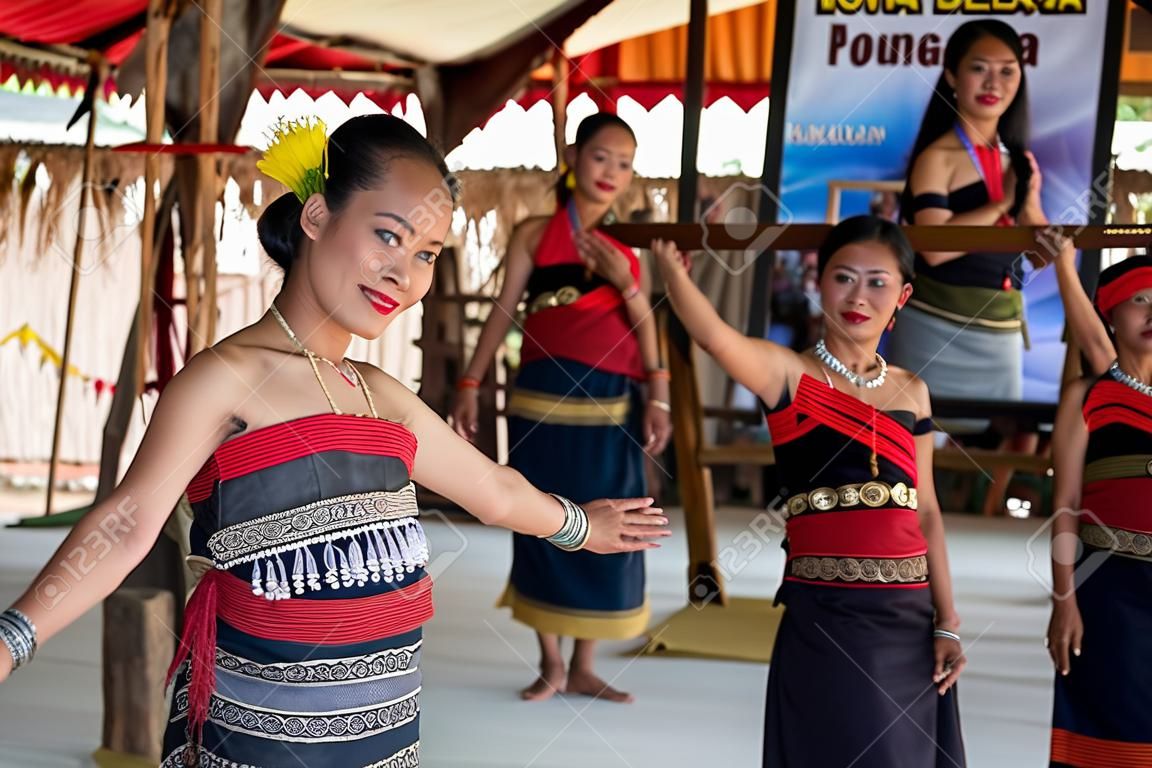 Beautiful young girls from Kota Belud Kadazan Dusun ethnic performed traditional dance during state level Harvest Festival in KDCA, Kota Kinabalu, Sabah Malaysia.