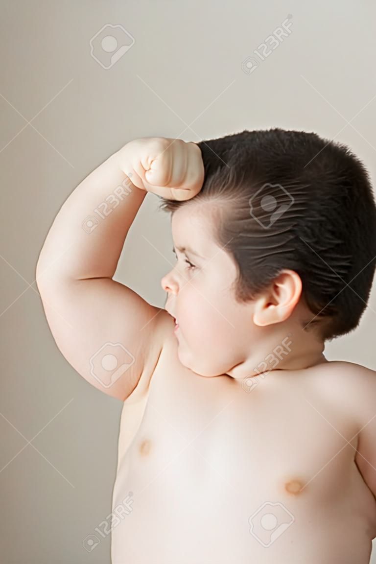 bad fat boy  shows his biceps  muscles