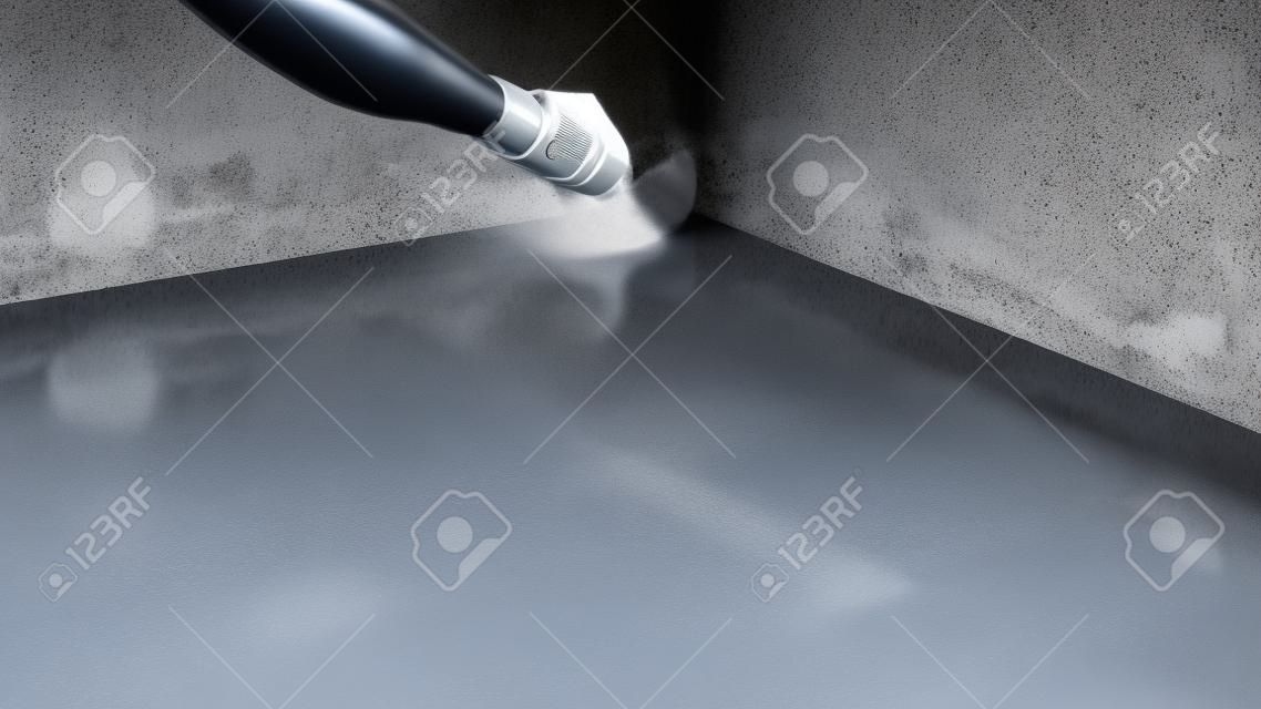 De meester zet waterdicht op een betonnen vloer met een borstel. Waterdicht betonmortel.