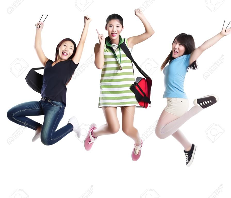 Emocionado grupo de estudiantes de la niña saltando - aislados en fondo blanco, modelo son los asiáticos