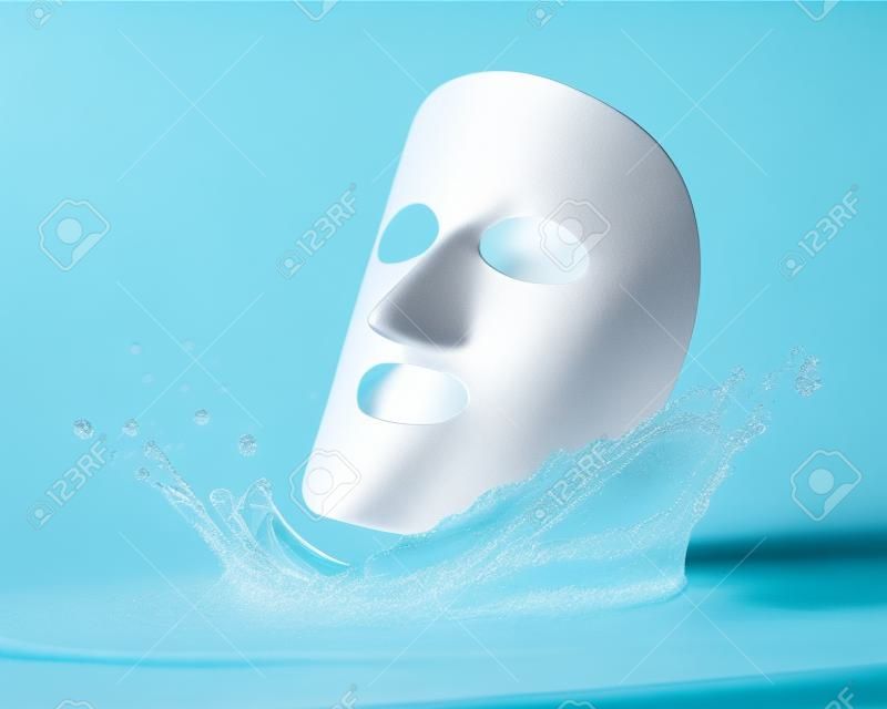 cloth facial mask with water drop, isolated over blue 