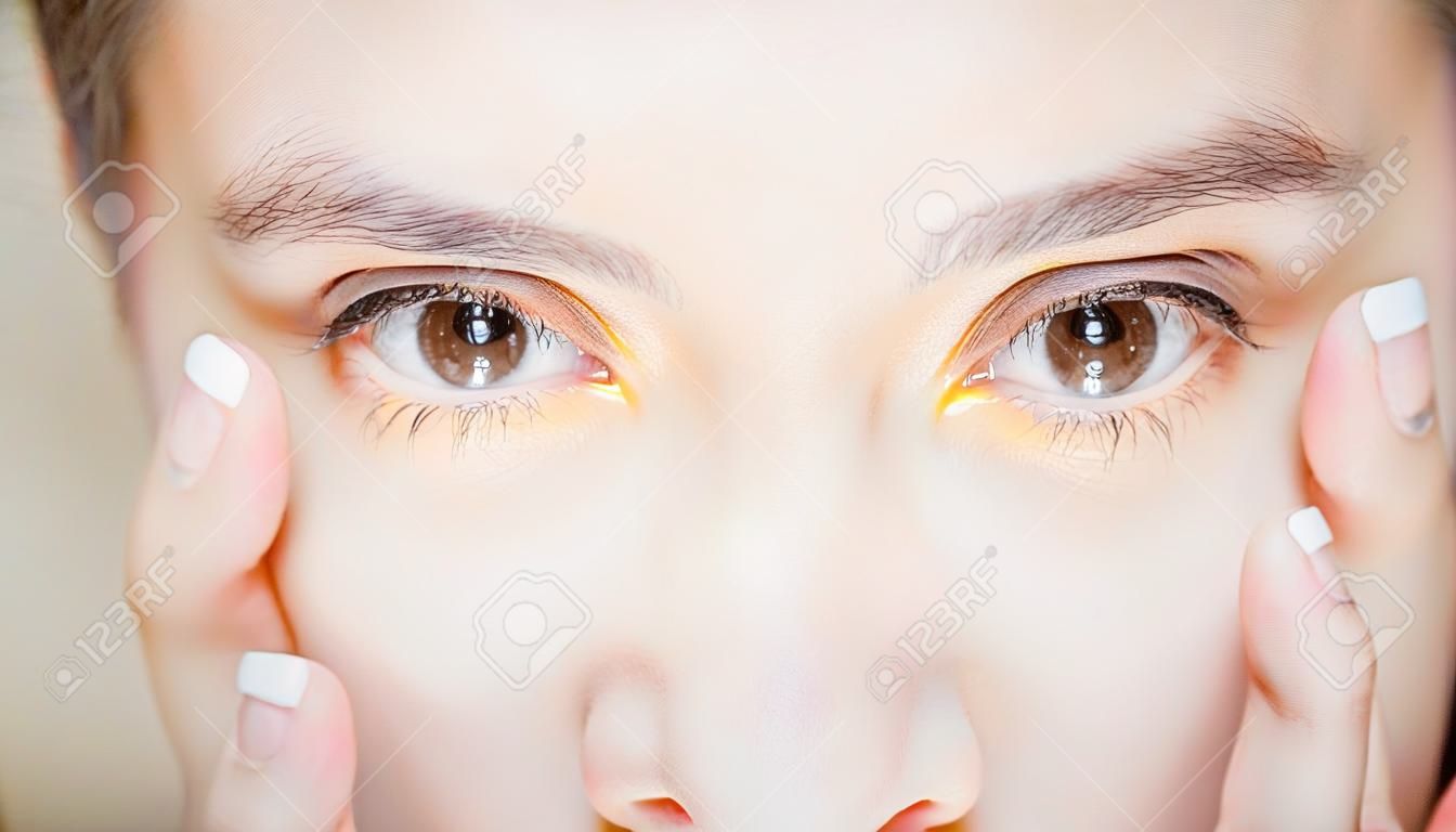 close up of beauty woman pointing her eye