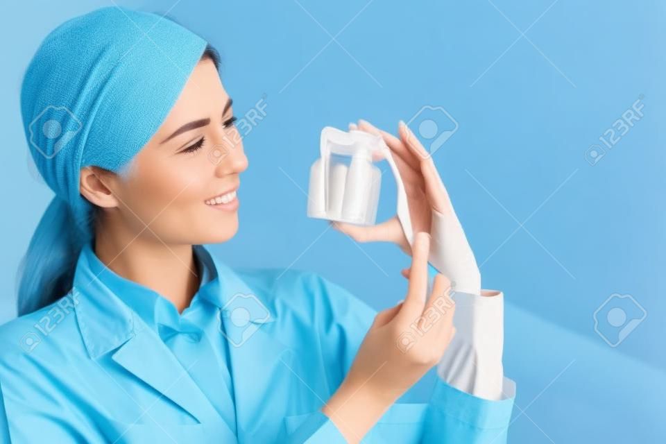 woman dentist take health tooth and teeth brush on the blue background