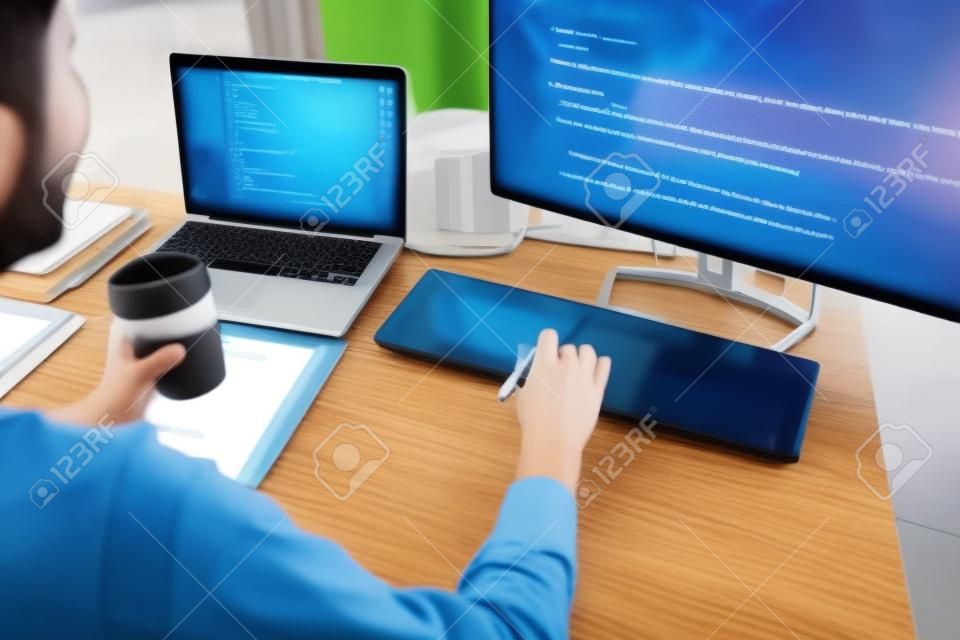 programmer work with Developing programming and coding technologies.  Programmer working with software on  many computer on the table in office. concept Website design