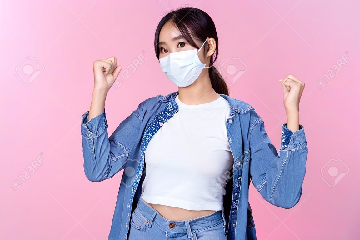 Young happy Asian woman wearing hygienic mask