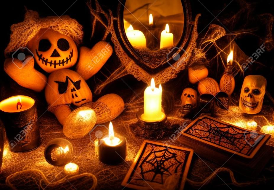 Magic ritual with voodoo doll, mirror, candles and tarot cards. Halloween concept, mystic or divination spell with occult and esoteric symbols. Vintage objects on witch table
