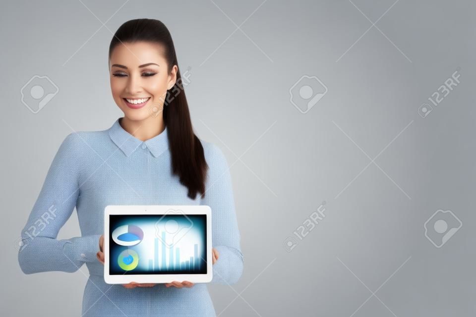 Beautiful business woman shows blank monitor on tablet isolated over white