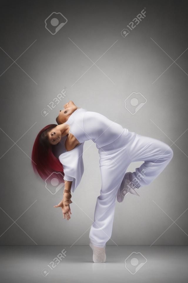 modern style dancer posing on studio background