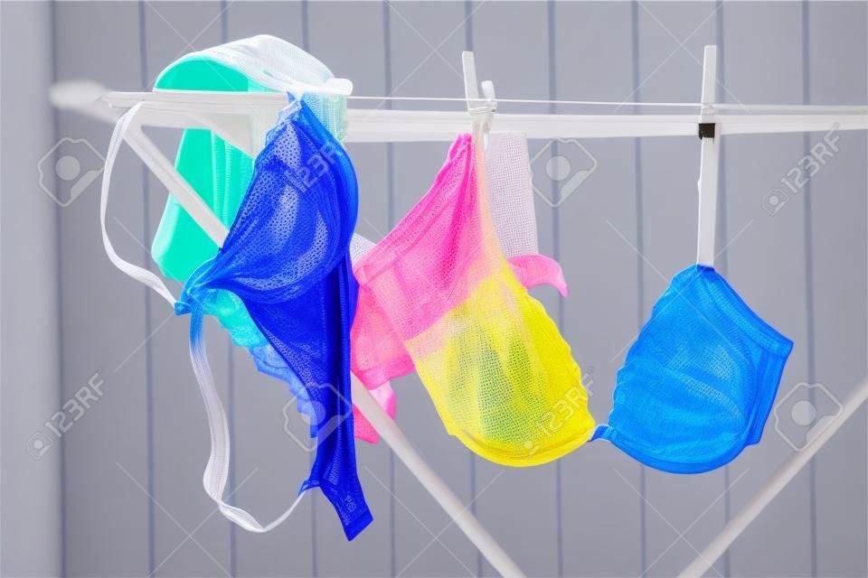 Colored bras and panties drying on clothesline