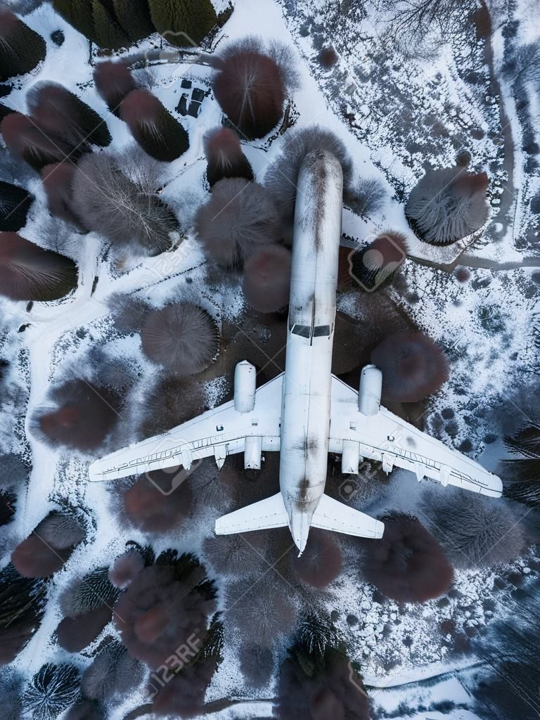 abandoned passenger plane wreck in the forest in winter