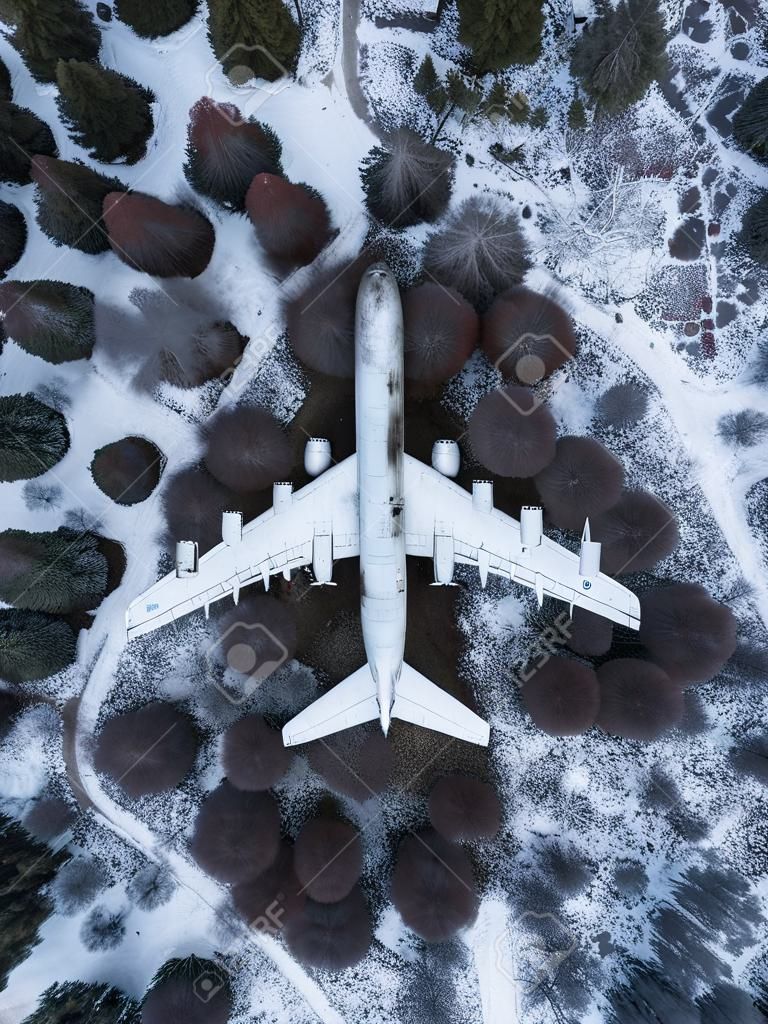 abandoned passenger plane wreck in the forest in winter