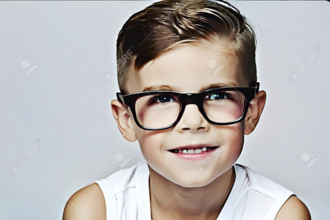 Portrait of young boy wearing glasses, studio