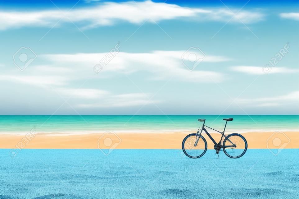 Bicycle standing on the beach sand on blue seascape background. Multicolored vibrant summertime horizontal outdoors image with filter.
