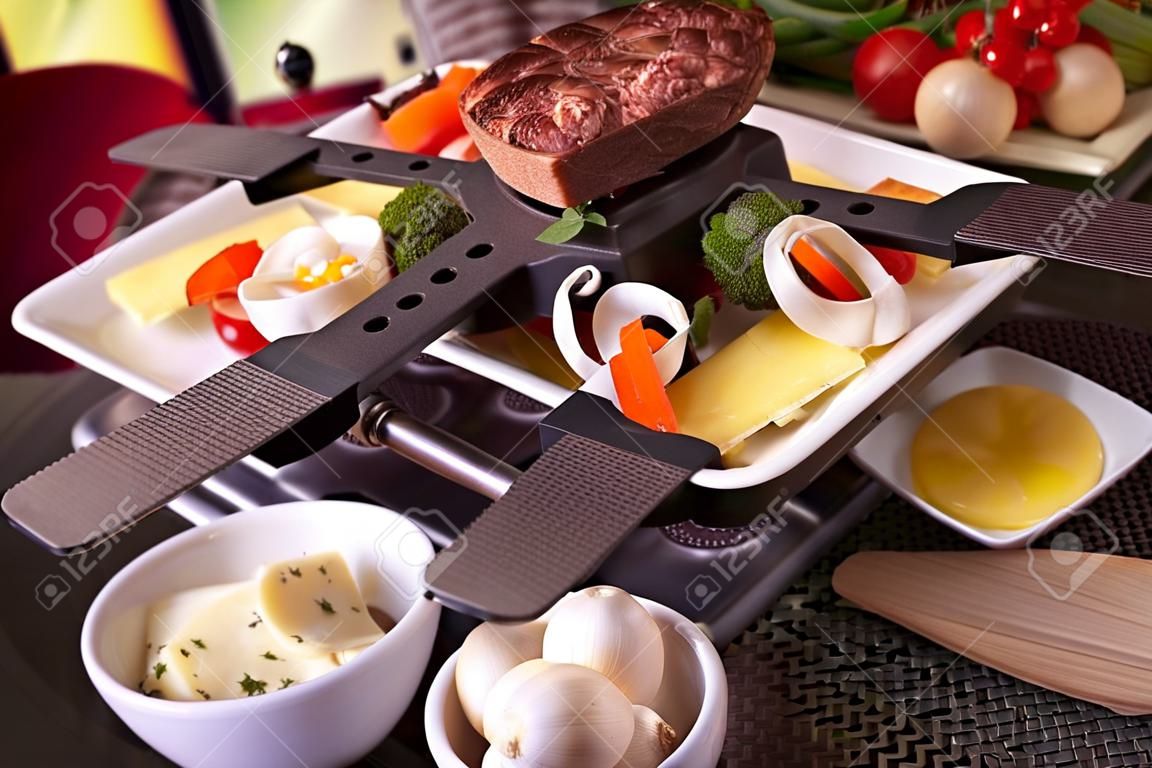Swiss raclette or the Dutch variant 'gourmetten'. A table filled with ingredients for a dish that is usually served on celebratory evenings like Christmas or New Years Eve in The Netherlands.