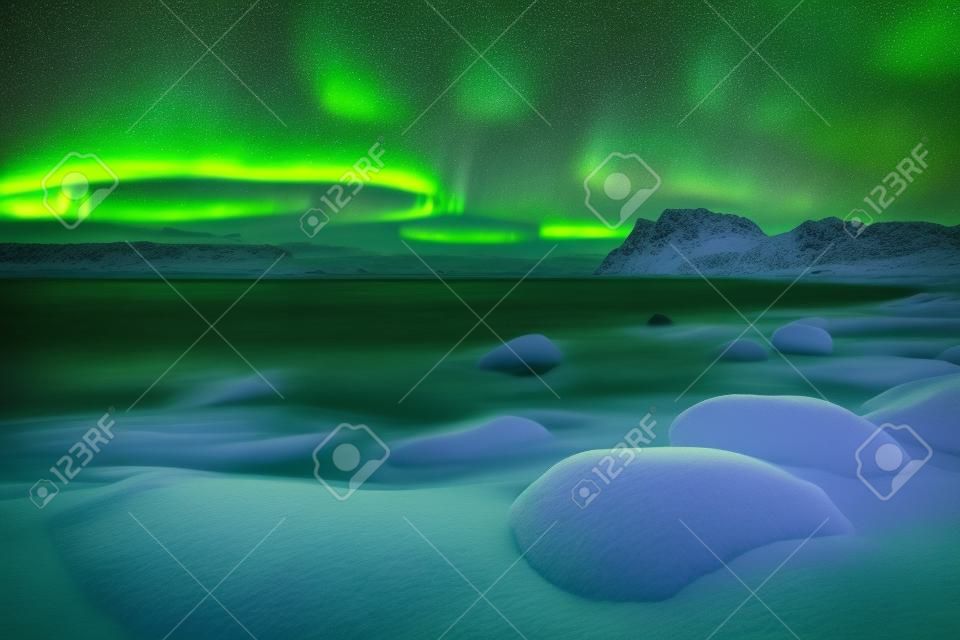 Die Aurora borealis über Uttakleiv Strand auf den Lofoten in Nordnorwegen im Winter.