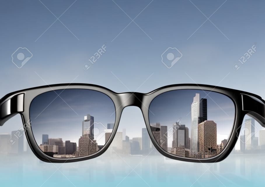 Eye glasses looking to city view, focused on glasses lens