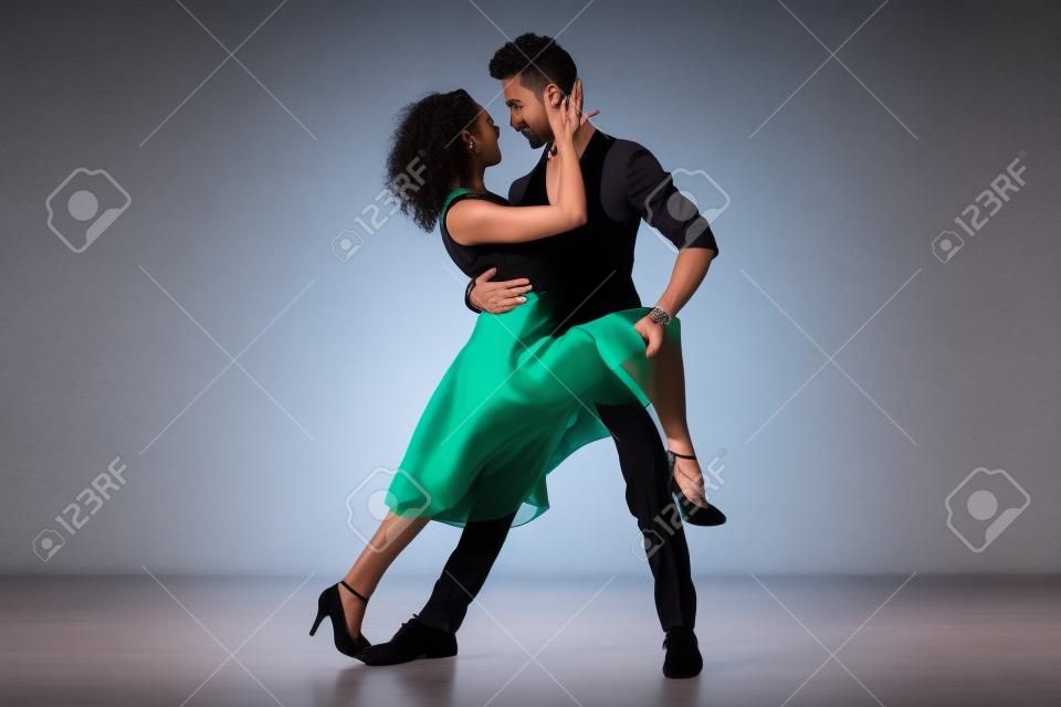 Social dance, bachata, kizomba, tango, salsa, people concept - Young couple dancing over white background