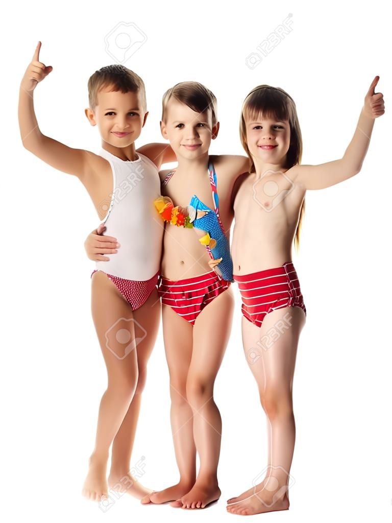 Three happy kids in swimsuit standing together, isolated on white