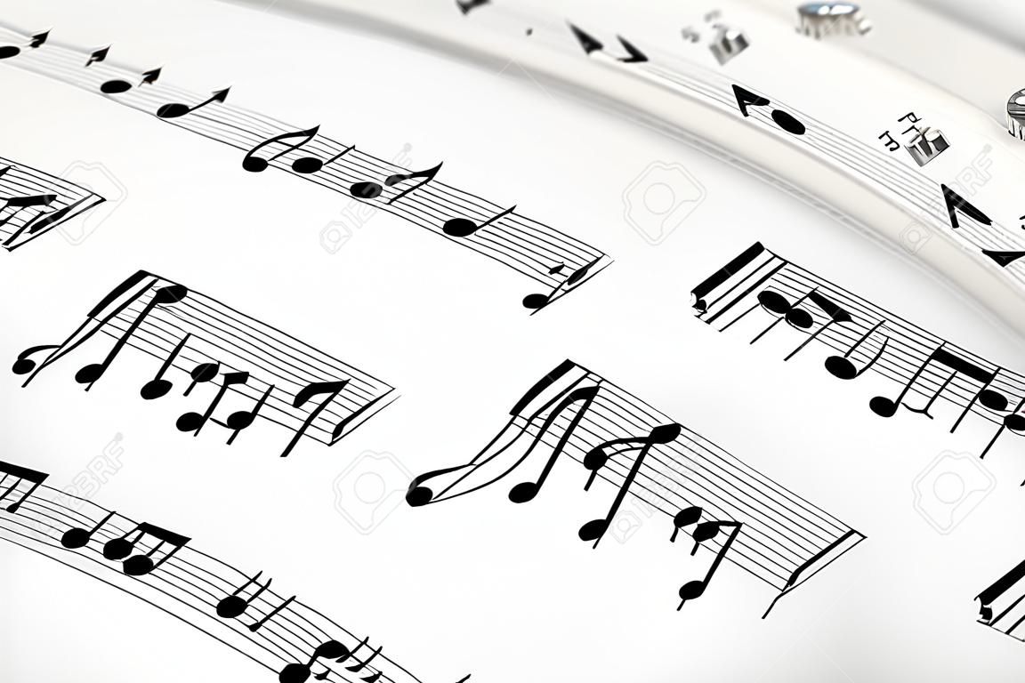 Musical concept background: macro view of white score sheet music with notes with selective focus effect