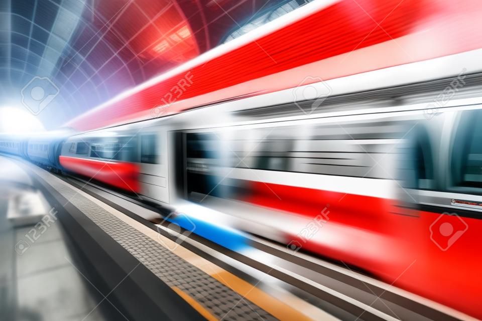 Creative abstract railroad travel and railway transportation industrial concept  modern red high speed electric passenger commuter train at station platform with motion blur effect