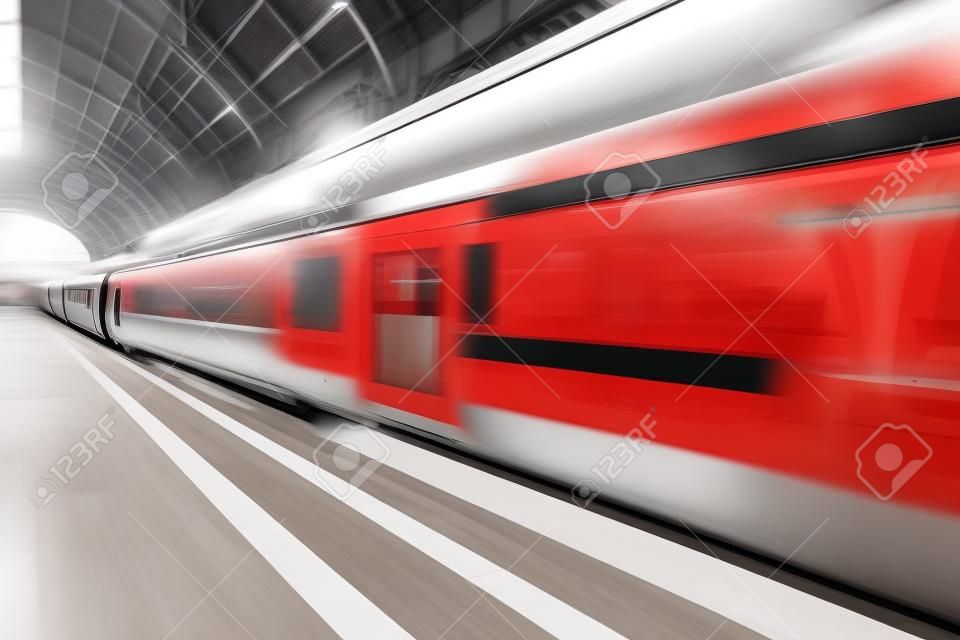 Creative abstract railroad travel and railway transportation industrial concept  modern red high speed electric passenger commuter train at station platform with motion blur effect