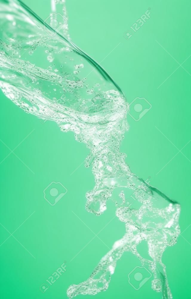 finger in water on a green background